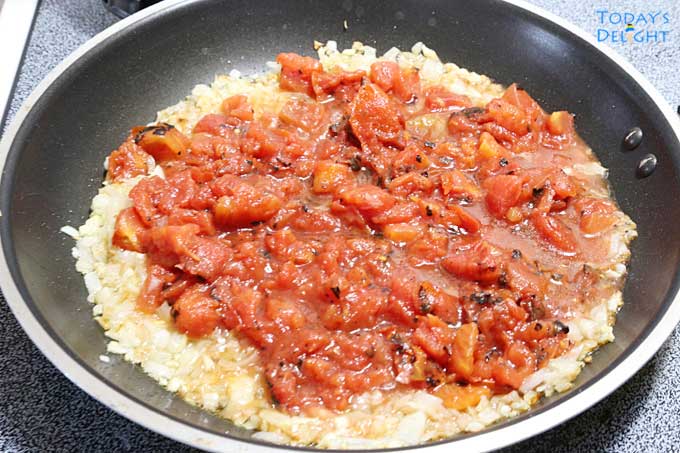 Onion, garlic and fire roasted tomatoes in pan.