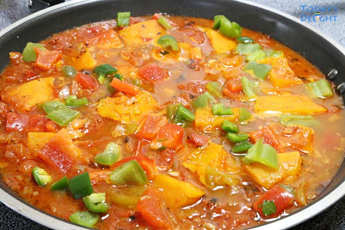 Cooking Shakshuka with Kabocha Squash in a pan.