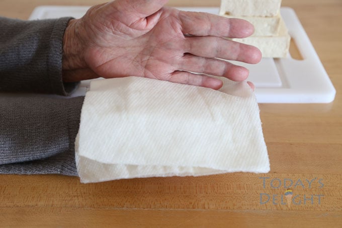 use hands to squeeze water out of tofu