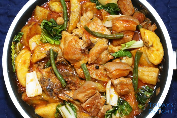 Pork and Chicken Pochero in a pan is a Filipino stew with pork, chicken, vegetables and plantain banana in tomato sauce.