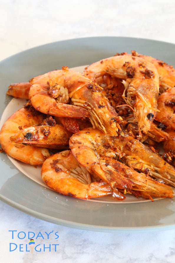 Pan-fried garlic butter shrimp on a gray plate.