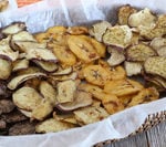 Baked pumpkin spice banana chips and sweet potatoes on a tray.