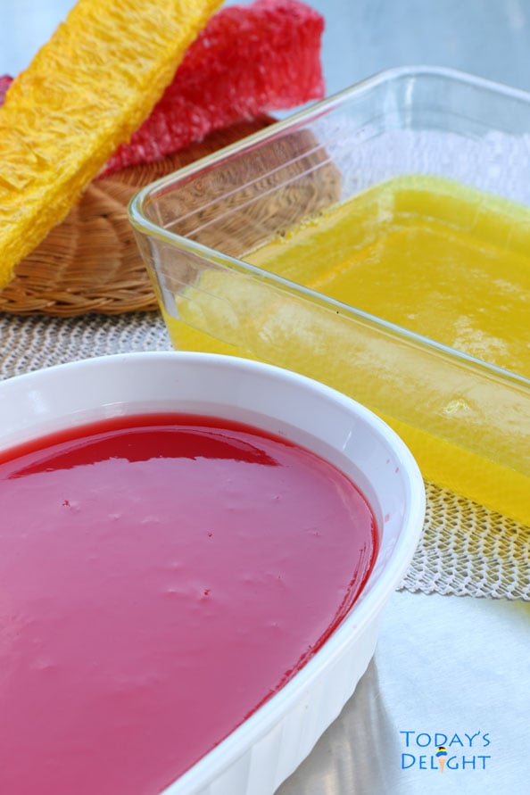 Yellow and red gulaman already made in separate containers and 2 sticks of yellow and red gulaman not made yet.