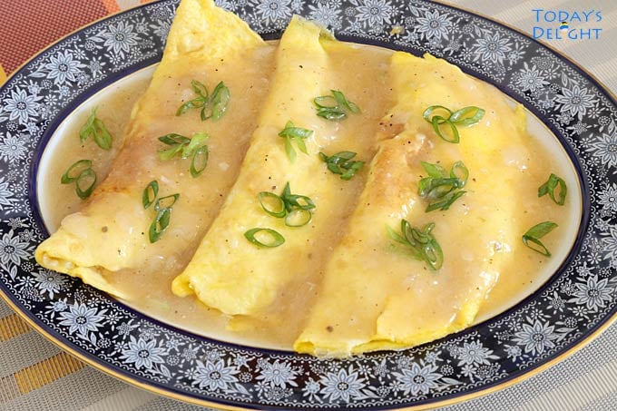 Sayote Omelette with Pork and Shrimp with gravy, garnished with green onion