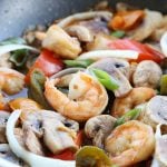 Shrimp, mushroom & vegetables in skillet.