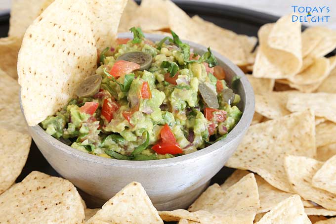 Salsa and tortilla chips on tray.