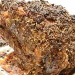 A medium-well done standing rib roast with rub on a rack