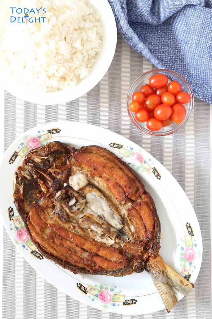 Fried daing na bangus (marinated milkfish) with rice and cherry tomatoes.