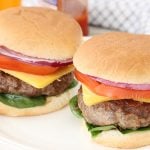 2 moist burger sandwiches with red onion, tomato, spinach and cheese.