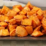 Oven roasted sweet potatoes on a gray square plate.