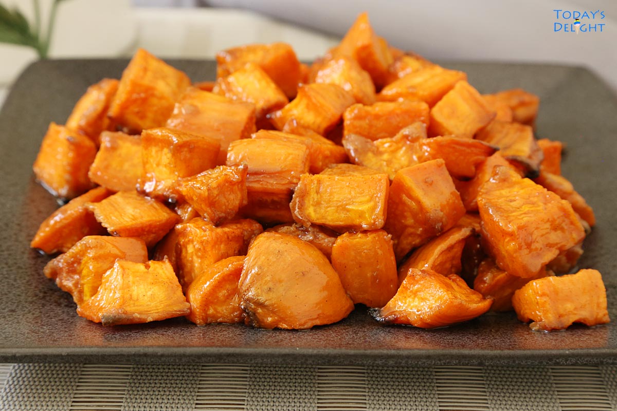 Oven roasted sweet potatoes on a gray square plate.