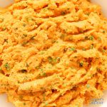 Close up of mashed sweet potatoes with chives.